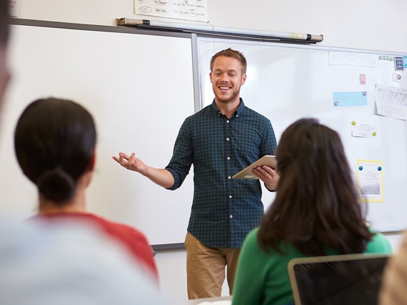 high-school-teacher-in-front-of-whiteboard-4-3