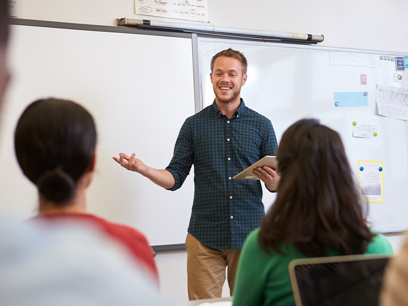 high-school-teacher-in-front-of-whiteboard-4-3
